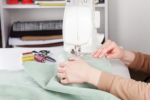 Sewing machine, stitching fabrics, needle in a round plan Stock Photos