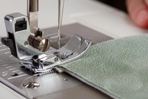 Sewing machine, stitching fabrics, needle in a round plan Stock Photos