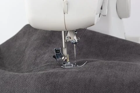 Sewing machine, stitching fabrics, needle in a round plan Stock Photos