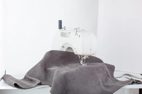Sewing machine, stitching fabrics, needle in a round plan Stock Photos