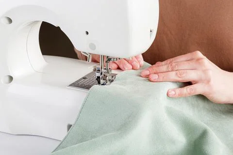 Sewing machine, stitching fabrics, needle in a round plan Stock Photos