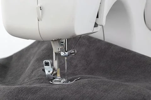 Sewing machine, stitching fabrics, needle in a round plan Stock Photos