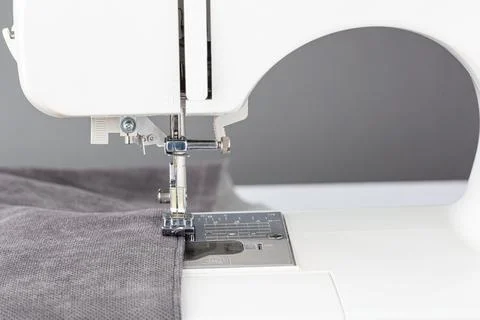 Sewing machine, stitching fabrics, needle in a round plan Stock Photos