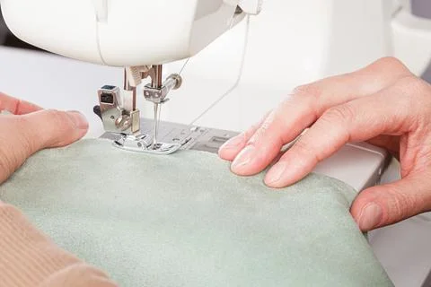Sewing machine, stitching fabrics, needle in a round plan Stock Photos