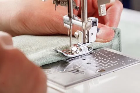 Sewing machine, stitching fabrics, needle in a round plan Stock Photos