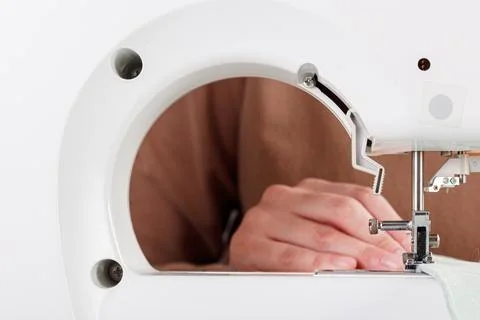 Sewing machine, stitching fabrics, needle in a round plan Stock Photos