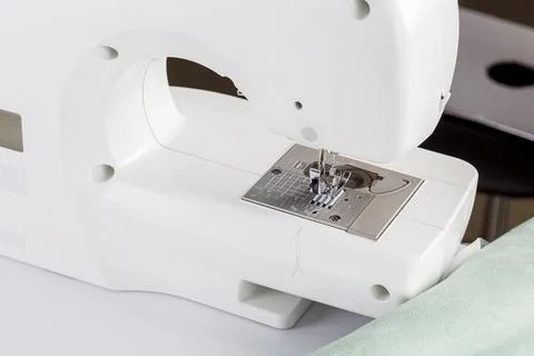 Sewing machine, stitching fabrics, needle in a round plan Stock Photos