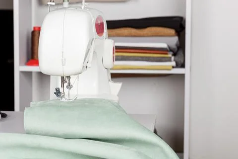 Sewing machine, stitching fabrics, needle in a round plan Stock Photos