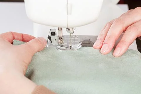 Sewing machine, stitching fabrics, needle in a round plan Stock Photos