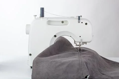 Sewing machine, stitching fabrics, needle in a round plan Stock Photos