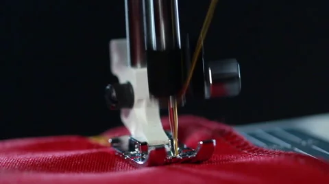 Sewing machine stitching seam on fabric. Yellow thread pattern on red fabric Stock Footage 62438119