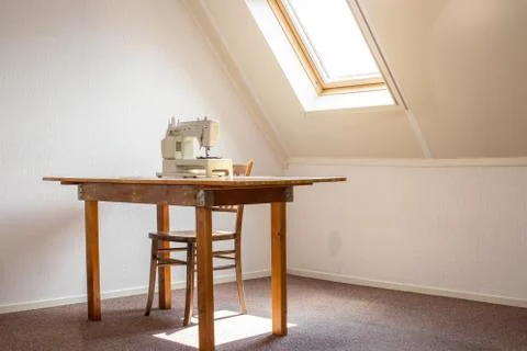 Sewing machine on table in a atelier studio, workplace or hobby room Stock Photos
