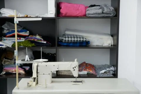 Sewing machine on table in workshop, tailor atelier Stock Photos