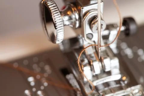 Sewing machine with thread in needle details Stock Photos