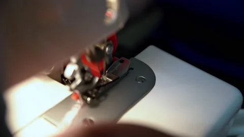 Sewing machine used for pattern stitching on red leather panel for female Stock Footage 141216943