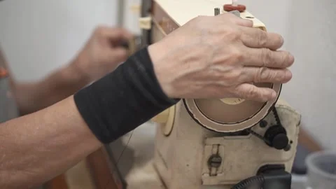 Sewing machine with vintage look. Process of sewing in atelier or workshop. Stock Footage 137679736