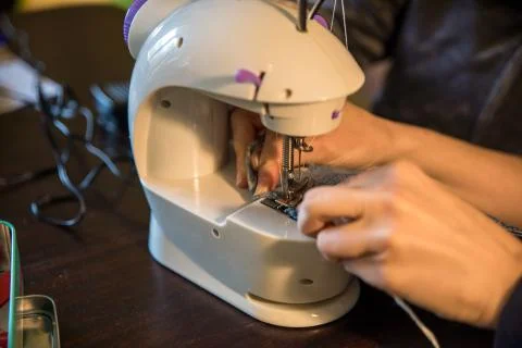 Sewing machine working on a pair of jeans Stock Photos