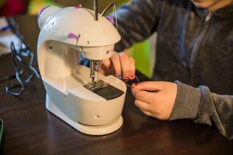 Sewing machine working on a pair of jeans Stock Photos