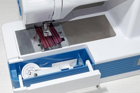 Sewing machine.Built-in compartment for tools and spare parts.Close-up. Foto stock