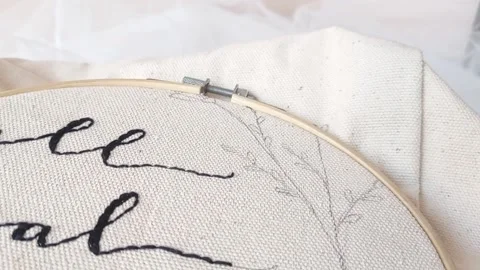 Sewing  a name on a white clothe Stock Footage 145623311