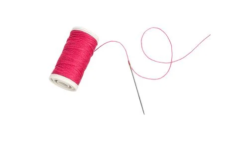 Sewing needle and spool of thread. Stock Photos