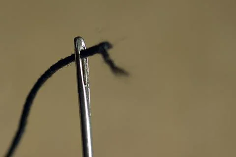 Sewing needle with a black thread Stock Photos