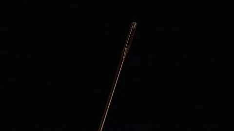 Sewing Needle Eye Shown in Extreme Macro Against a Black Background, Highlightin Stock Footage 341422167