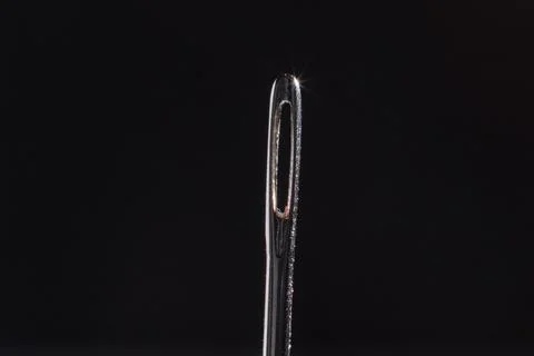 Sewing needle on the table, macro photo with blurred background Stock Photos