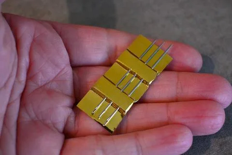 Sewing needles held in a hand for mending clothes Stock Photos