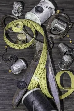 Sewing needles, Thimbles, Scissors, Measuring tape, Buttons, Spools of blac.. Stock Photos