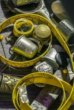 Sewing needles, Thimbles, Scissors, Measuring tape, Buttons, Spools of blac.. Stock Photos