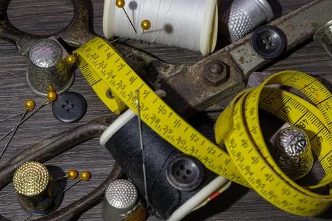 Sewing needles, Thimbles, Scissors, Measuring tape, Buttons, Spools of blac.. Stock Photos