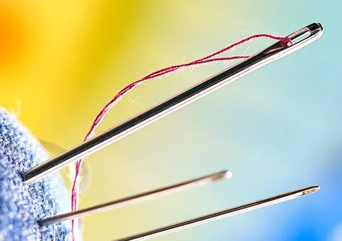 Sewing needles with threads close up Stock Photos