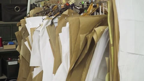 Sewing paper patterns on hangers in the tailor studio. A bunch of sewing molds Stock Footage 164148648