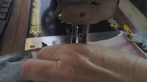 Sewing patchwork on 100 year old antique sewing machine Stock Footage 331286328