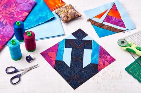 Sewing patchwork of block anchor surrounded by accessories Fotos de archivo