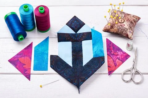 Sewing patchwork of block anchor surrounded by accessories Stock Photos