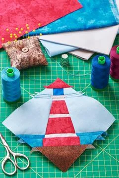 Sewing patchwork of block of lighthouse surrounded by accessories Fotos Stock