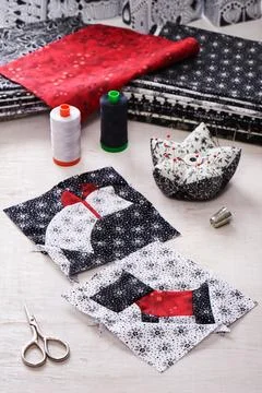 Sewing patchwork of blocks white cat and black dog, sewing accessories Stock Photos