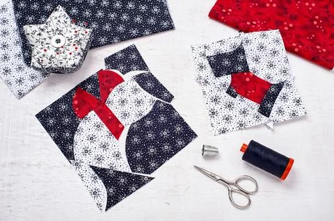 Sewing patchwork of blocks white cat and black dog, sewing accessories Stock Photos