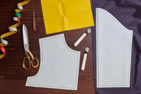 Sewing pattern on fabric, tracing wheel, tracing paper, sewing equipment Stock Photos