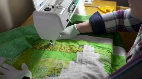 Sewing a pattern on a homemade quilt with a sewing machine - slow motion Stock Footage 171453581