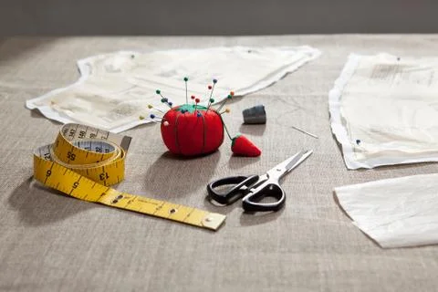 Sewing pattern, pin cushion and tape Stock Photos