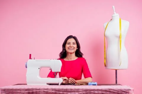 Sewing pattern,sewing machine and maniken in studio pink background.seamstress Stock Photos