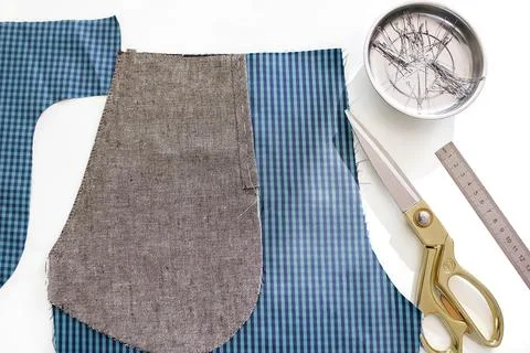 Sewing a pocket on trousers, a view from the wrong side. Stock Photos