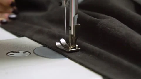 The Sewing Process Involving a Sewing Machine on Distinctly Dark Fabric Material Stock Footage 310260396