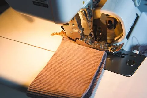 Sewing process on an overlock machine - macro shot. Selective focus Stock Photos