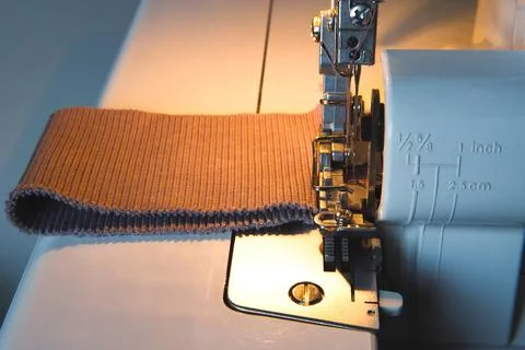 Sewing process on an overlock machine - macro shot. Selective focus Stock Photos