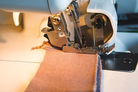 Sewing process on an overlock machine - macro shot. Selective focus Stock Photos
