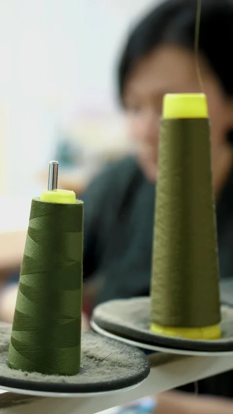 Sewing process. A skein of thread. Close-up. Spools of thread on working sewing Stock Footage 316893872